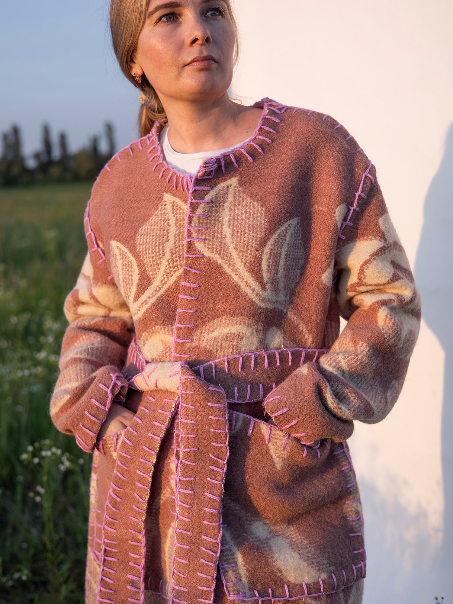 hand-stitched pink seam detail sustainable wool coat