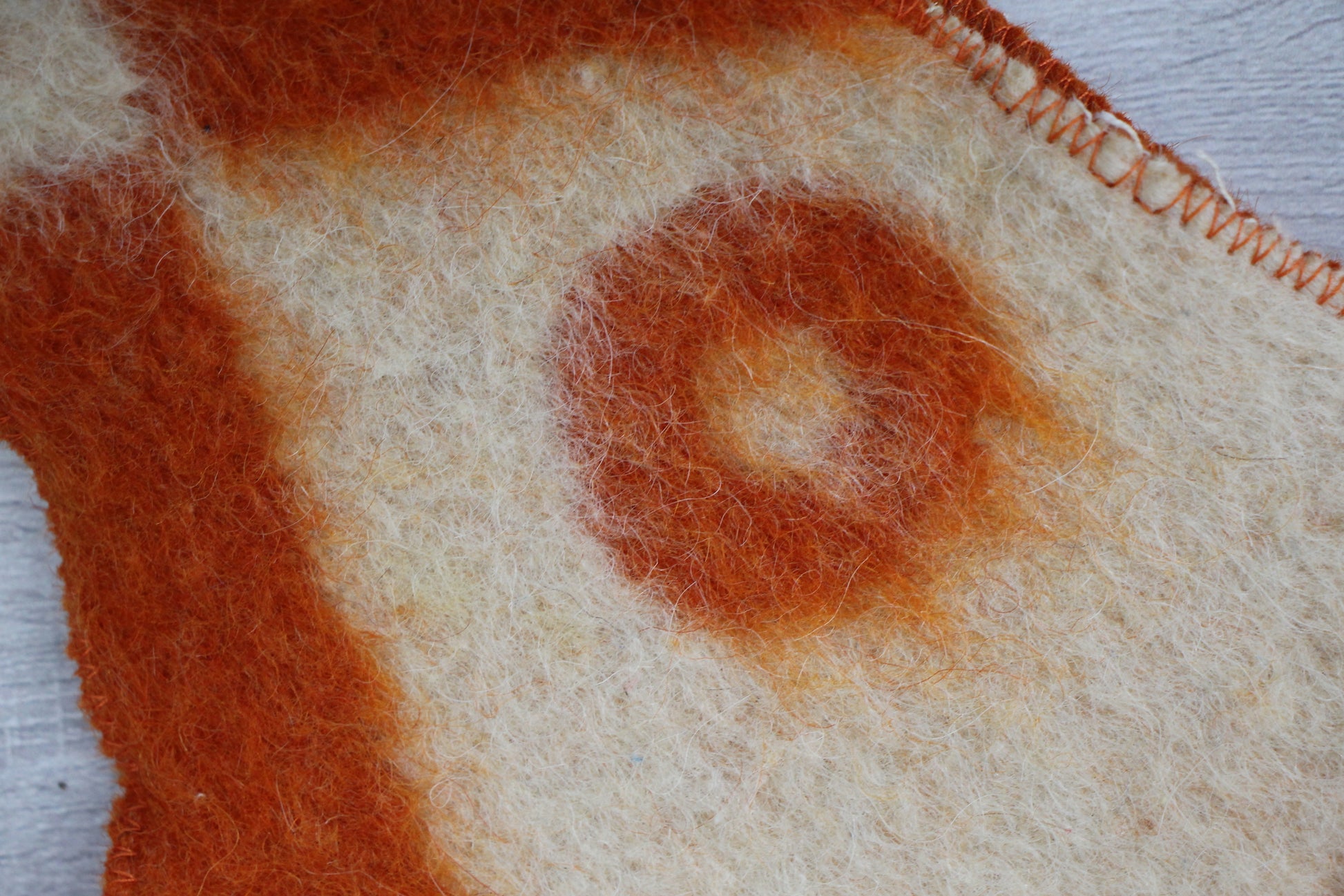 close-up pattern warm orange beige spots on vintage wool blanket sauna hat