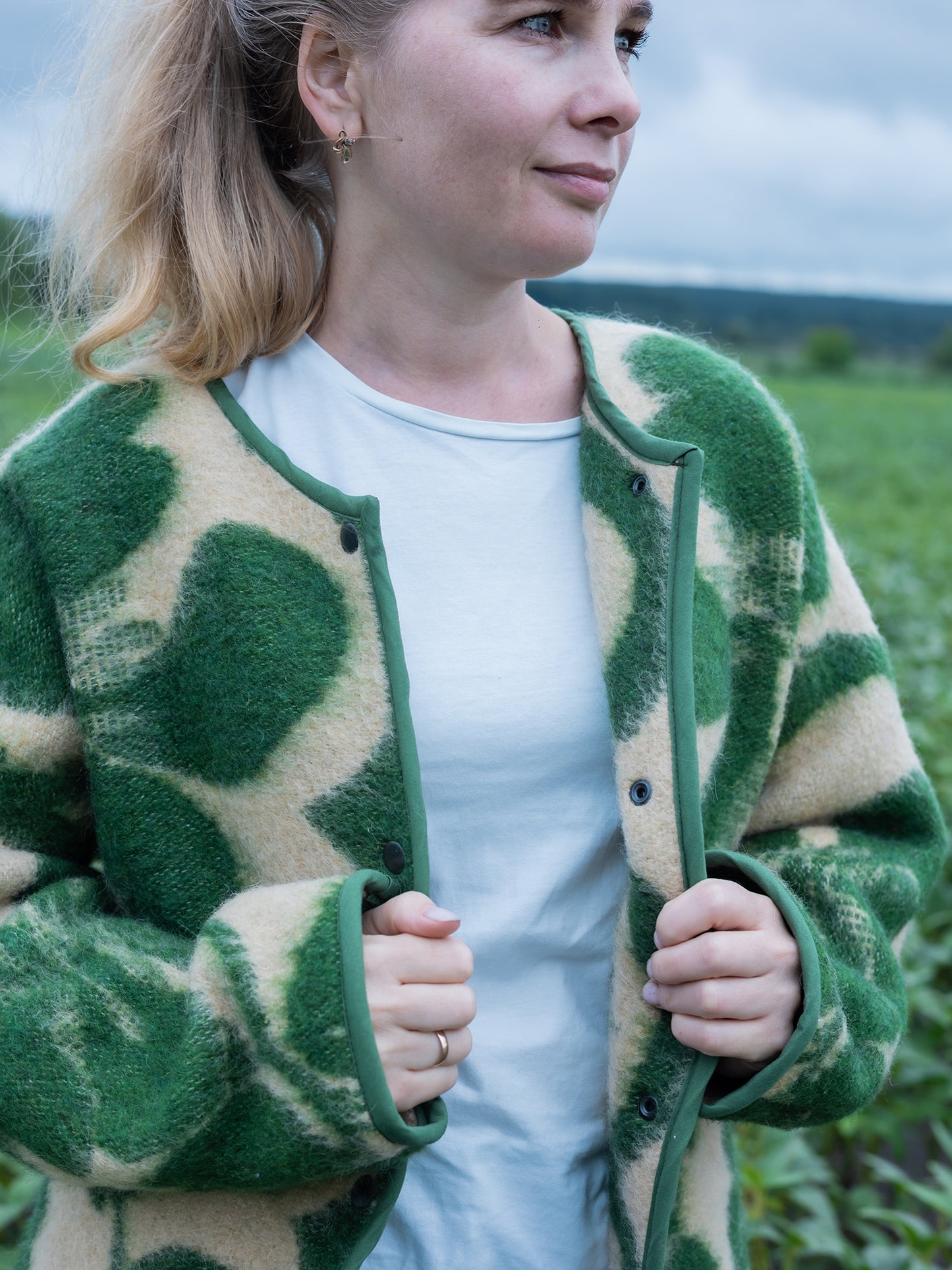 close-up rust green floral tapestry pattern wool blanket coat