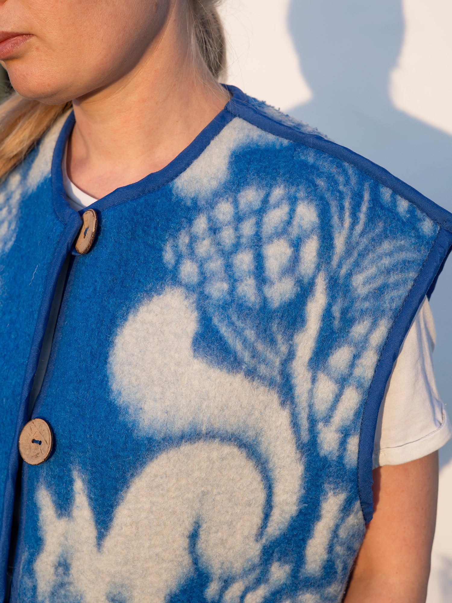 vest laid flat showing full squirrel and pine pattern vintage blanket fabric