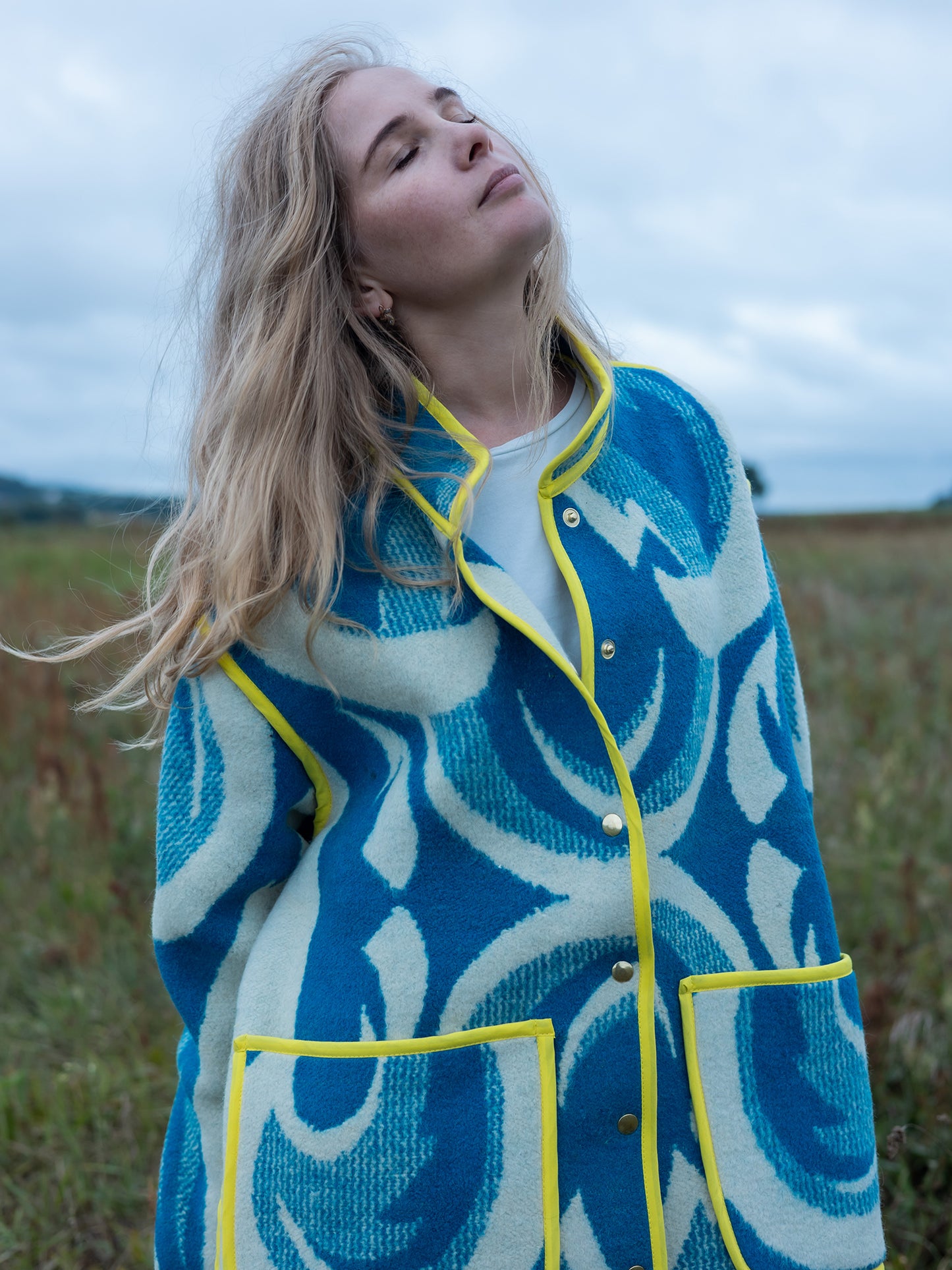 bright yellow bias-tape edge detail on wool coat