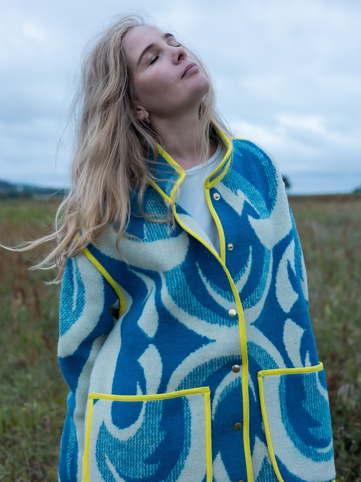 bright yellow bias-tape edge detail on wool coat